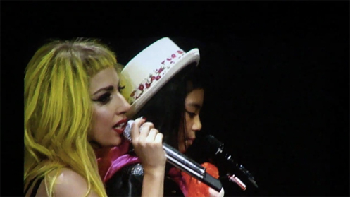Maria Aragon on stage with Lady Gaga performing Born This Way